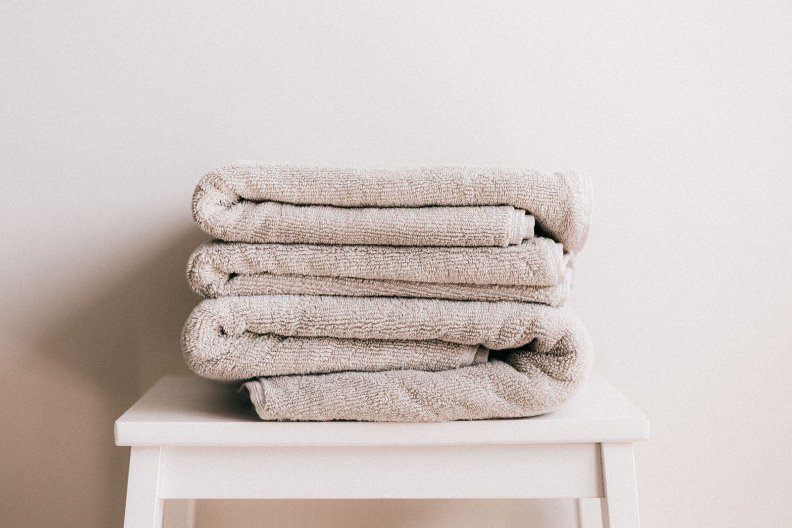 A neat stack of clean folded beige towels